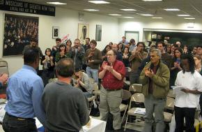 Members of the Freightliner Five speak to a solidarity meeting in New York City